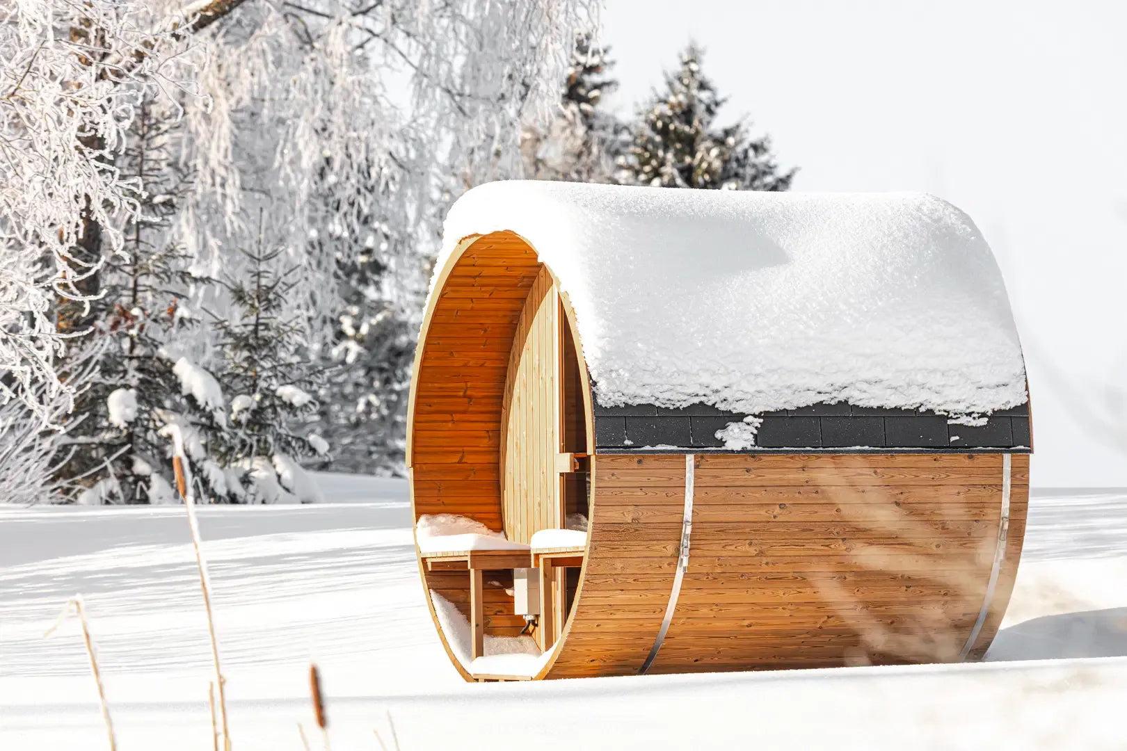 Hekla Barrel Sauna 210 outdoor barrel sauna in snowy setting (lifestyle image).