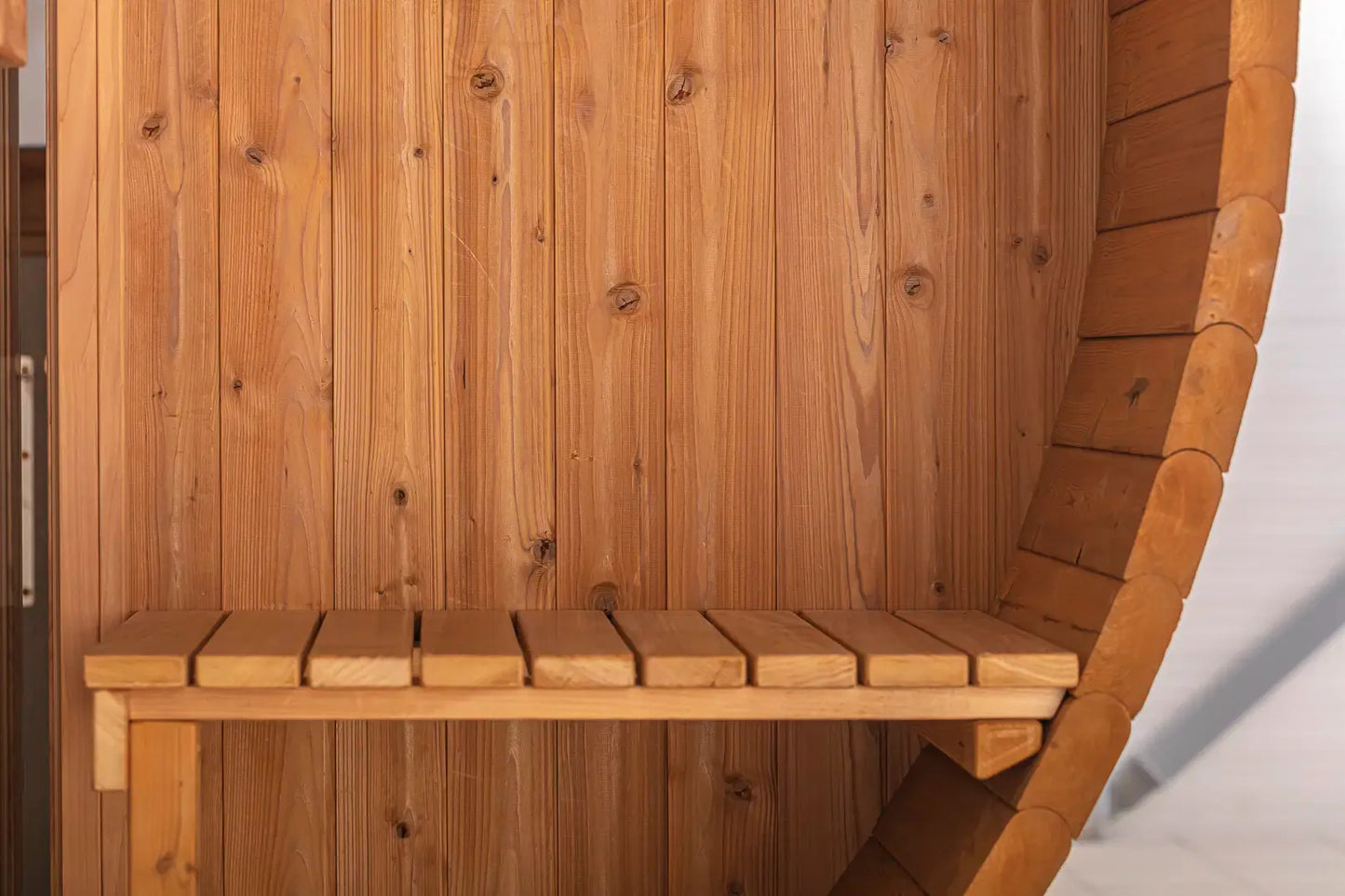 Close-up of interior bench seating inside the Hekla Barrel Sauna 210.