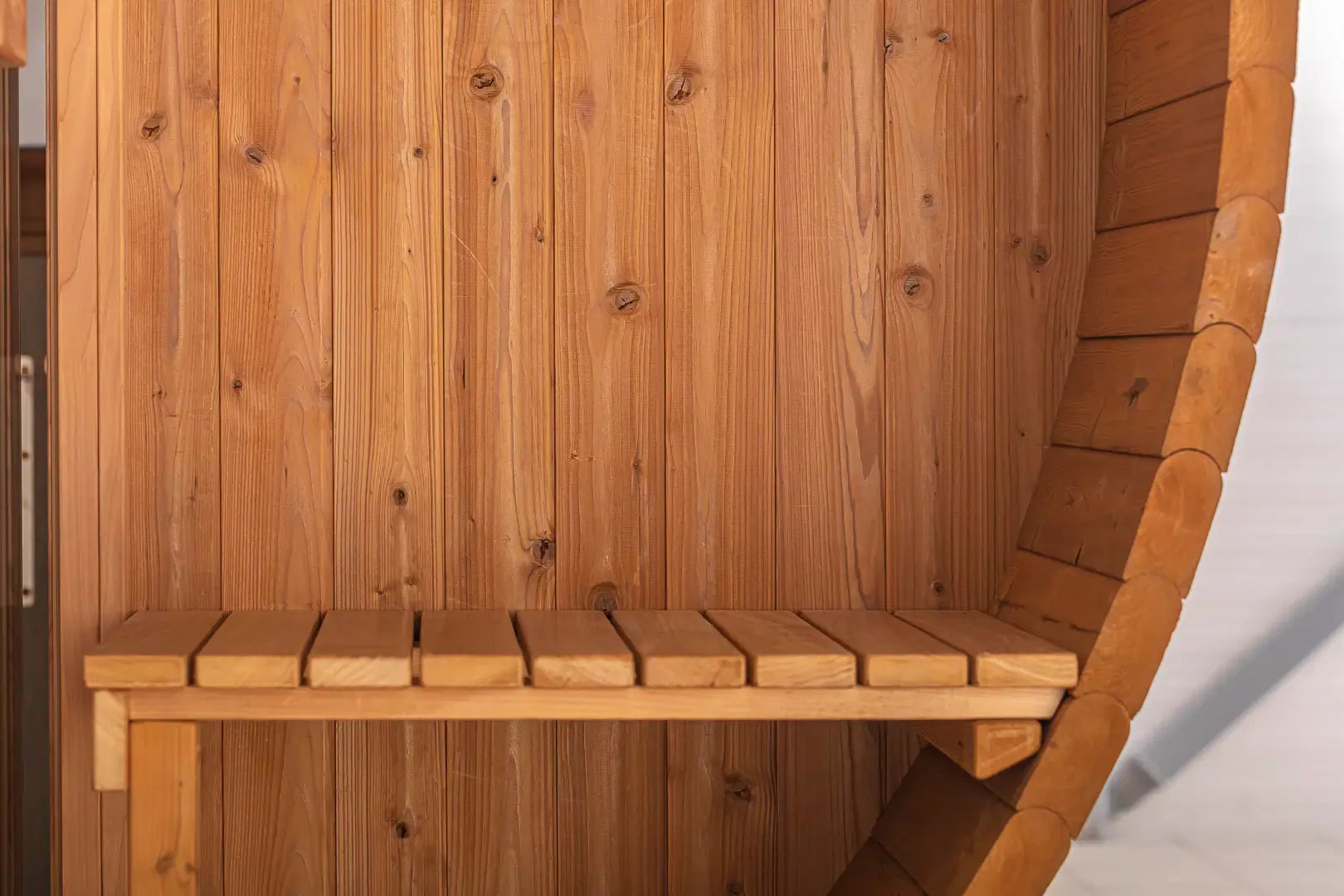 Close-up of interior bench seating inside the Hekla Barrel Sauna 210.