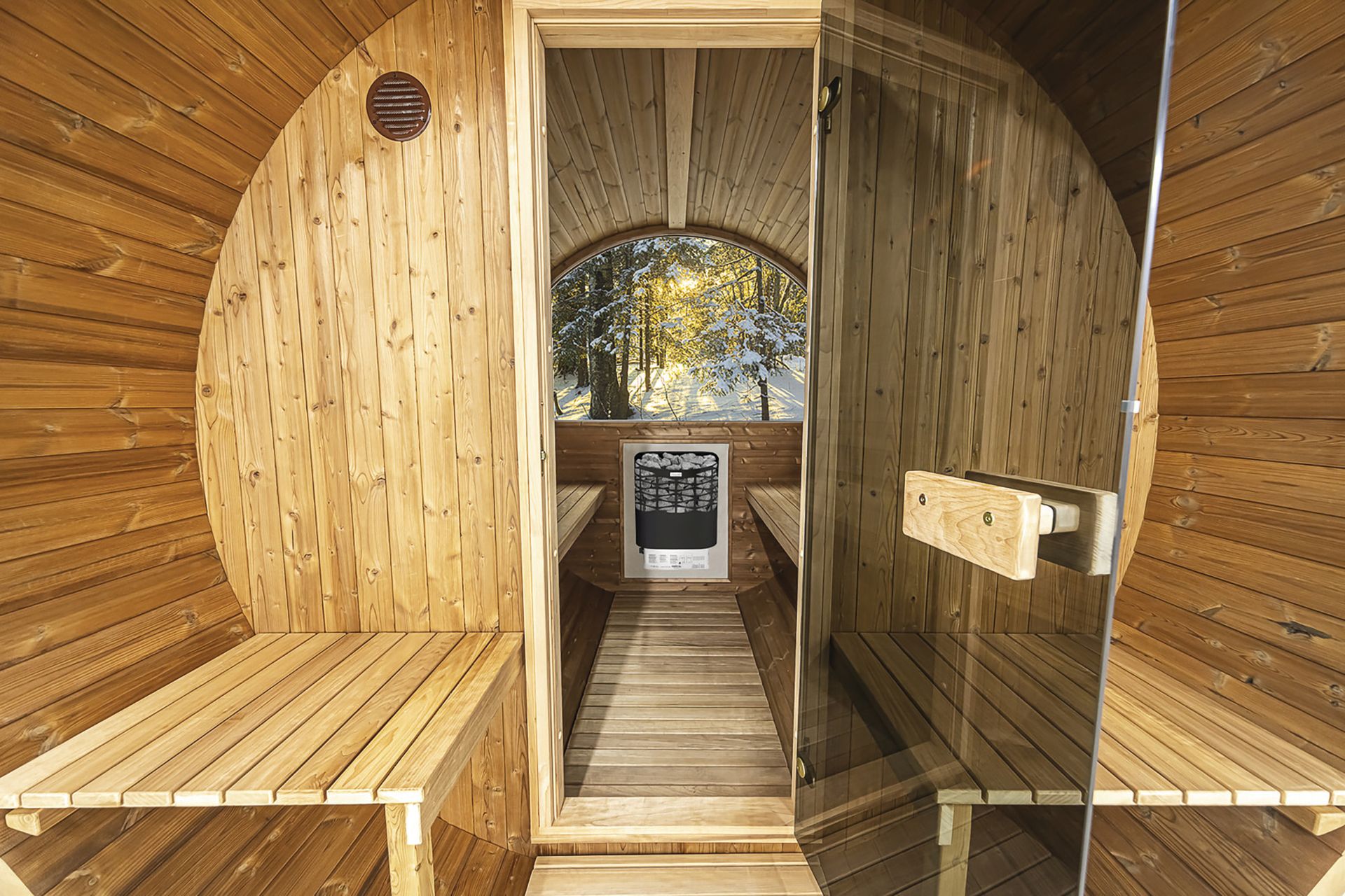Interior view of the Hekla Barrel Sauna 210 with heater visible.
