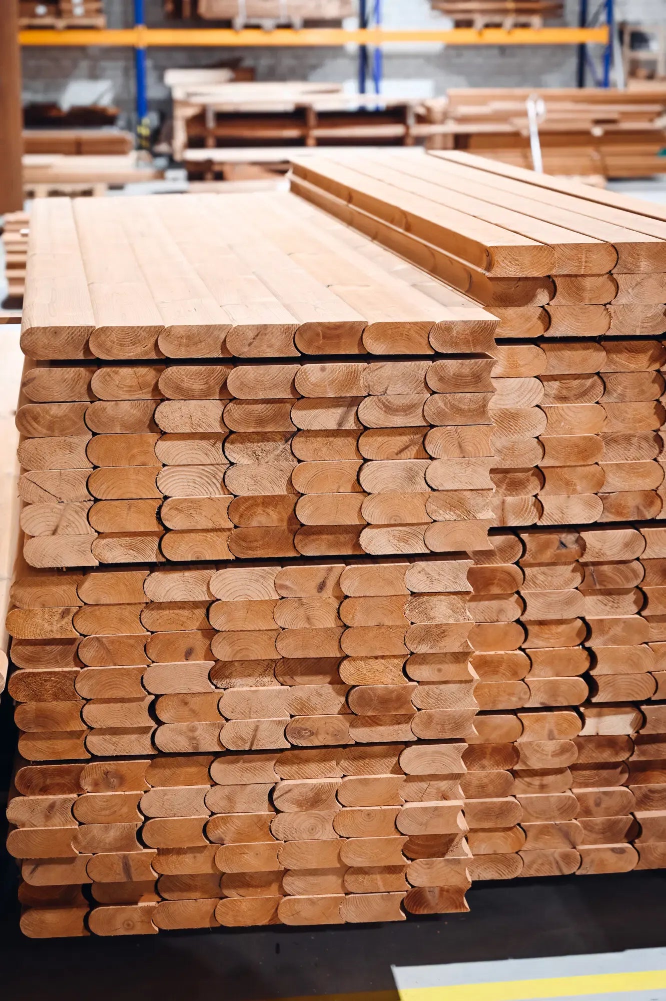 Timber stave material stack close-up for barrel sauna construction.