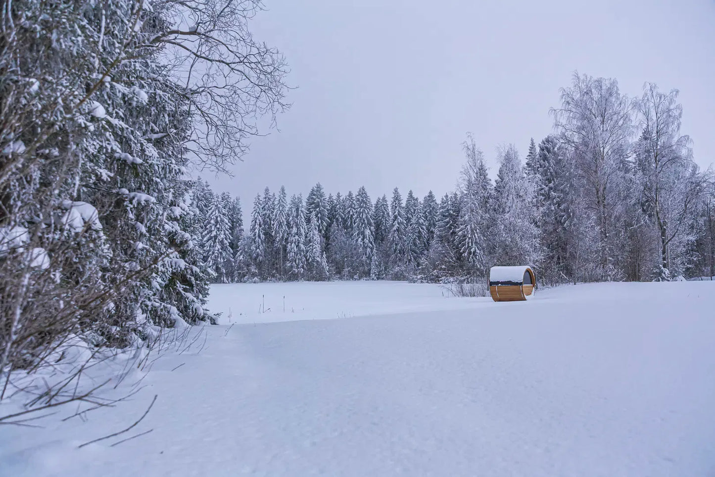 Winter landscape lifestyle image used for Hekla Barrel Sauna 210 marketing.