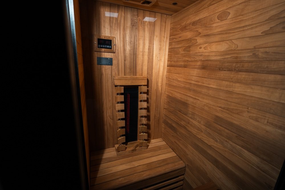 Interior wide view showing controls and heater inside the Hekla IR100 sauna.